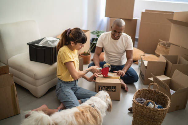 istock Young couple packing and moving boxes at home 1397373678