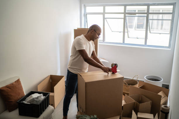 istock Young man packing and moving boxes at home 1397373689