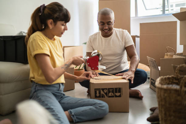 istock Young couple packing and moving boxes at home 1397373690