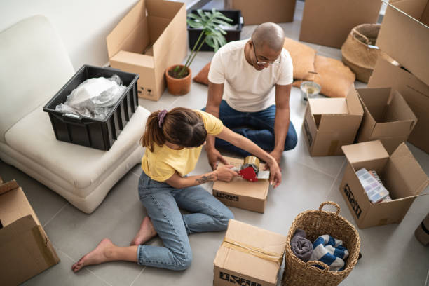 istock Young couple packing and moving boxes at home 1397373705