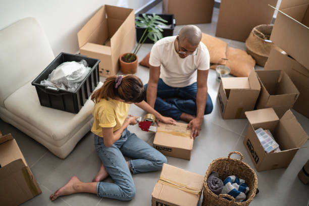 istock Young couple packing and moving boxes at home 1397373707