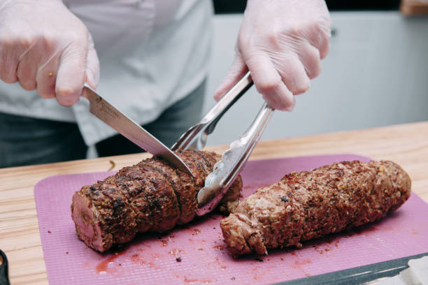 istock Cooking meat rolls in the cooking class. Beef roll with spices. The process of cutting a roll, close-up. 1397374508