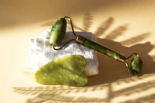istock Jade Gua sha scraper and facial massager on beige background. 1397374579