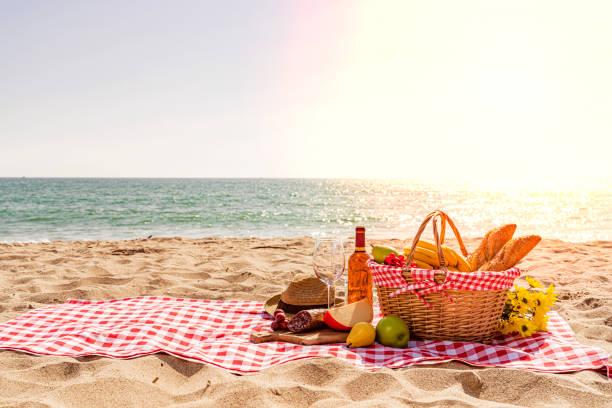 istock Wicker picnic basket by the beach at sunset 1397374599