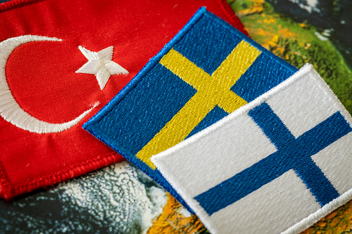 Turkish flag next to the flags of Finland and Sweden Concept of a political conflict between a member of the North Atlantic Pact and candidates aspiring to join