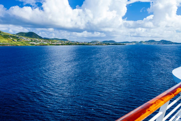 View from our cruise ship pass by cloud-shrouded mountain during our approach to the  Caribbean islands of St Kitts and Nevis. stock photo