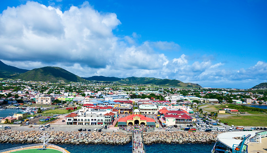 From the front of our cruise ship we see the Saint Kitts Welcome Center and downtown Basseterre with ts Airport, beautiful forests and mountains in the distance.