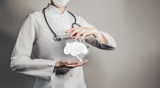 Photo of Unrecognizable doctor holding highlighted handrawn Brain in hands. Medical illustration, template, science mockup.