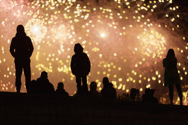 istock People in black silhouettes and fireworks as background 1397378508