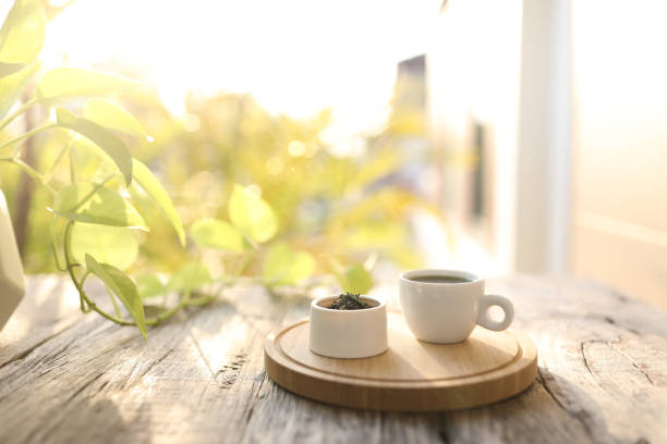 istock Tea cup and tea pot and green leaves on wooden table 1397379482