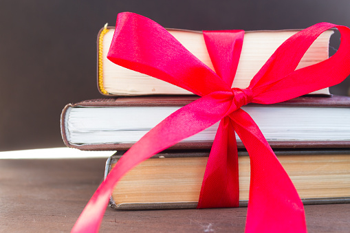 Books with gift ribbon. Book as a present