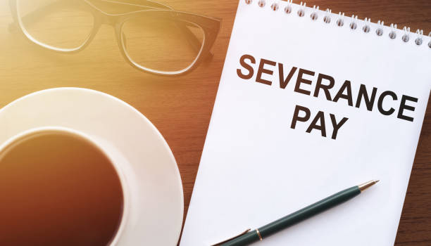istock Text, the inscription, the phrase Severance Pay is written in a notebook that lies on a dark table with a cap of coffee and glasses. Business concept. 1397384704