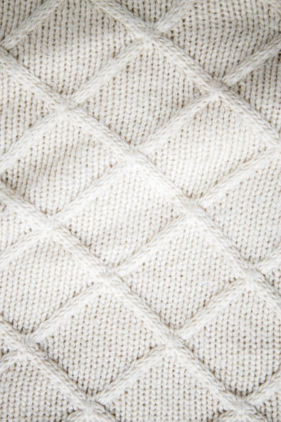 istock Knitting. Knitted background of milky color with a relief pattern 1397389884