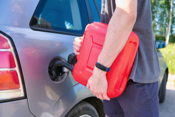 istock Filling a stalled car with gasoline from a canister 1397391535