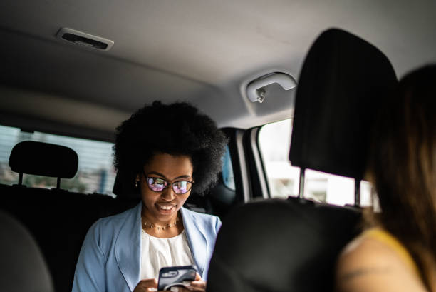 istock Businesswoman using smartphone in a cab 1397393213