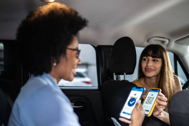 istock Woman paying a cab driver using contactless payment on smartphone 1397393231