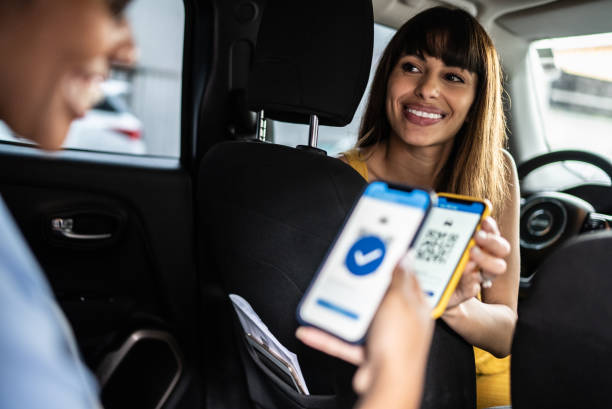 istock Woman paying a cab driver using contactless payment on smartphone 1397393242