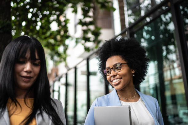 istock Business women talking while walking outdoors 1397393281