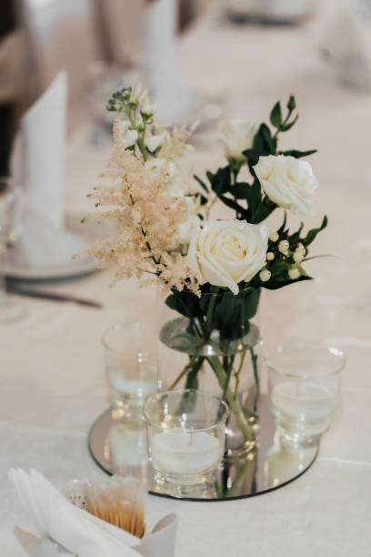 istock Wedding decor. A yellow rose stands on a table with greenery and candles 1397394087