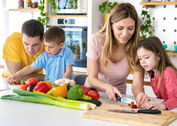 istock Family in kitchen cooking vegetarian meal. 1397394159