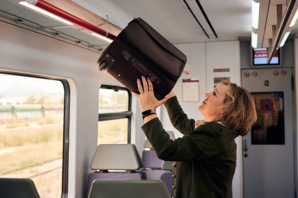 istock Woman leaves suitcase in train compartment 1397394258
