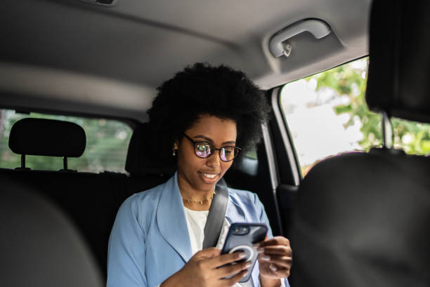 istock Businesswoman using smartphone in a cab 1397394261