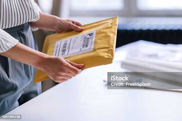 An Unrecognizable Businesswoman Preparing A Package For Shipping Stock Photo - Download Image Now