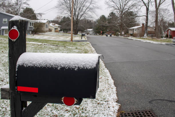 istock winter snow-covered suburban street-side black and red mailbox -no mail 1397395544