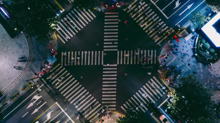 T/L Drone Point View of City Street Crossing at Night