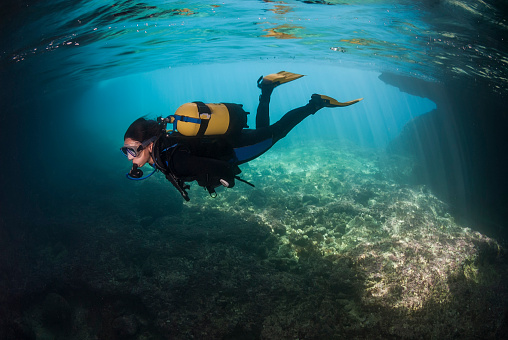 Scuba diving couple. Beautiful sea. Underwater scene with group of scuba divers,  enjoy  in blue, shallow water. Scuba diver point of view.