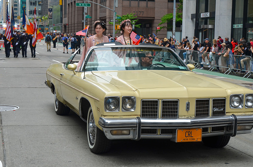 Participants on a car march down Sixth Avenue during the first ever Asian American and Pacific Islander Cultural and Heritage Parade in New York City on May 15, 2022.