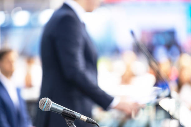 Speaker giving a speech at business conference, presentation or media event stock photo