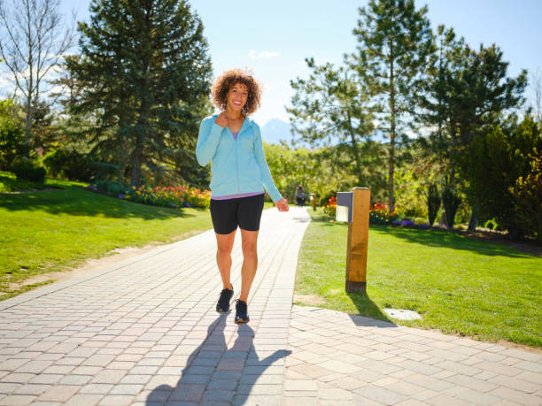 istock Woman Walking in a Park 1397401305