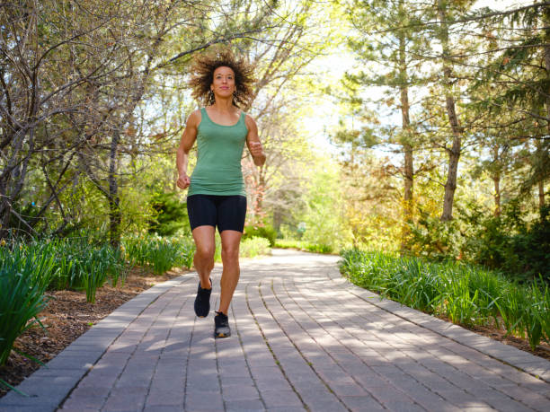 istock Woman Walking in a Park 1397401361