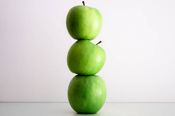 istock Green apples on a white background close-up. 1397402147