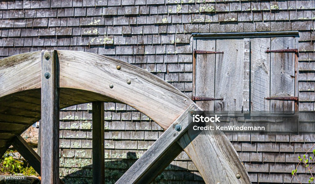 Water Wheel and Window The wooden water wheel and shuttered window of the old Dexter  Grist Mill (1638) in Sandwich, Massachusetts Old Stock Photo