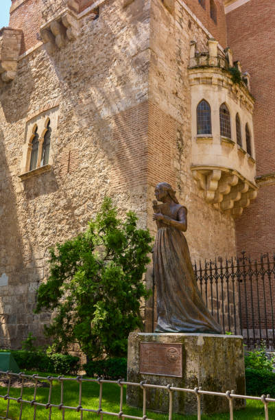 Archiepiscopal Palace of Alcala de Henares. Region of Madrid, Spain. Alcala de Henares, Spain - May 13, 2022. Statue of Catherine of Aragon facing the Tower of Tenorio, Archiepiscopal Palace; view from Plaza de las Bernardas square. Alcala de Henares, Region of Madrid, Spain. alcala de henares stock pictures, royalty-free photos & images