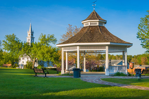 The town bandstand and village church in the center of Norfolk, Massachusetts on a springtime late afternoon.