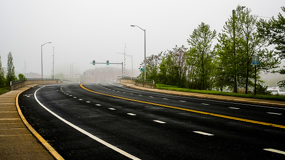 Norwalk, CT, USA - May 15, 2022: Beautiful morning fog near downtown with road view and bridge