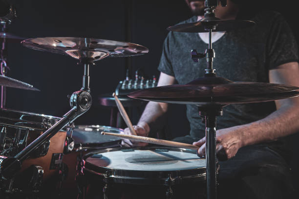 istock A male drummer plays the drums in a dark room. 1397405392