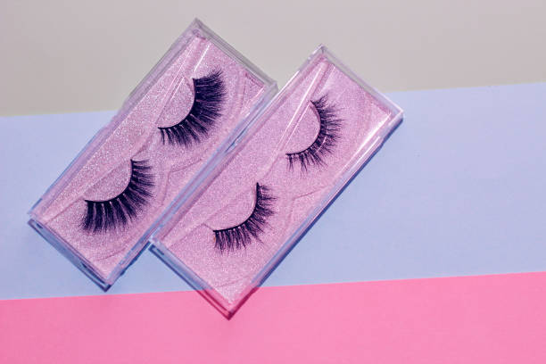 istock Fluffy cosmetic false eyelashes on paper geometric background 1397405482