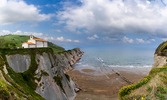 A view of the San Telmo Hermitage chapel and Flysch rock formations on the Basque Country coast in Zumaia