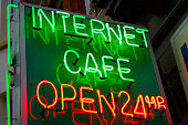 Green and red neon sign for a twenty four hour internet cafe