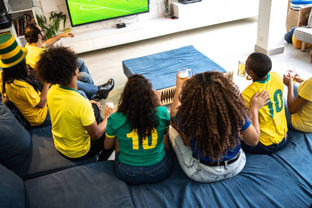 istock Friends watching soccer match together at home 1397407852
