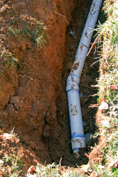 PVC Pipe Being Laid in an Underground Trench stock photo