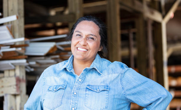 istock Hispanic woman working at lumberyard, smiling 1397409171