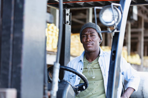 istock African-American man at lumberyard driving forklift 1397409313
