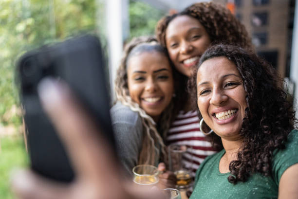 istock Friends using mobile phone taking selfie or filming at home 1397409315