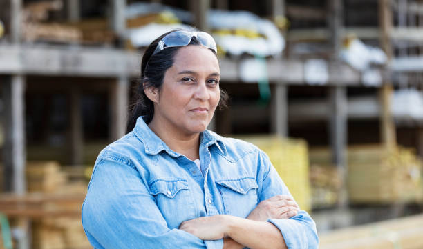 Mature Hispanic woman working at lumberyard