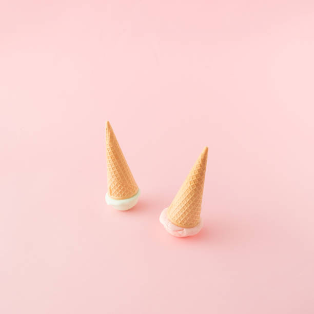 istock Two ice cream cones with green and pink scoops turned upside down on pink background. Top view. Minimal concept. 1397409379